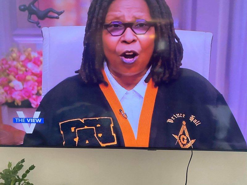 whoopi goldberg wearing a masonic jacket